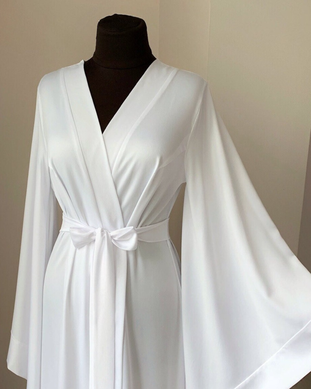 a woman's white robe on a mannequin