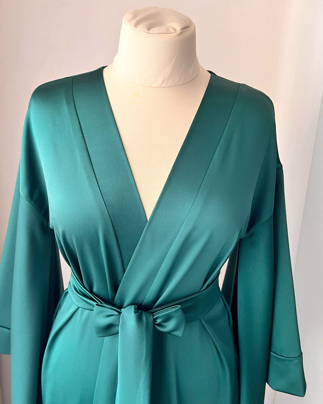 a woman's green robe on a mannequin