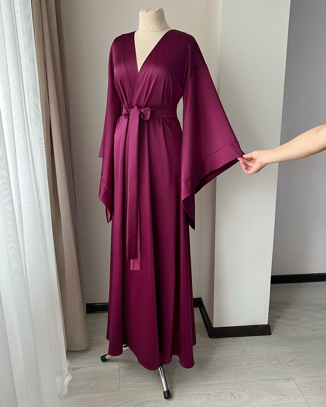 a woman's purple robe on a mannequin