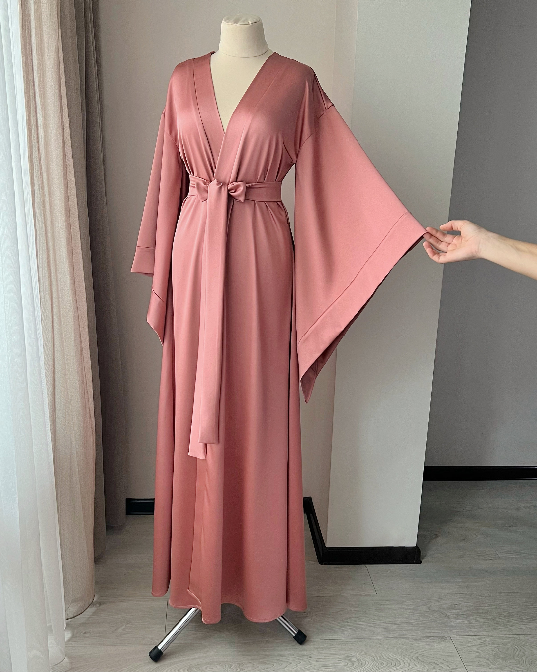 a woman's pink robe on a mannequin