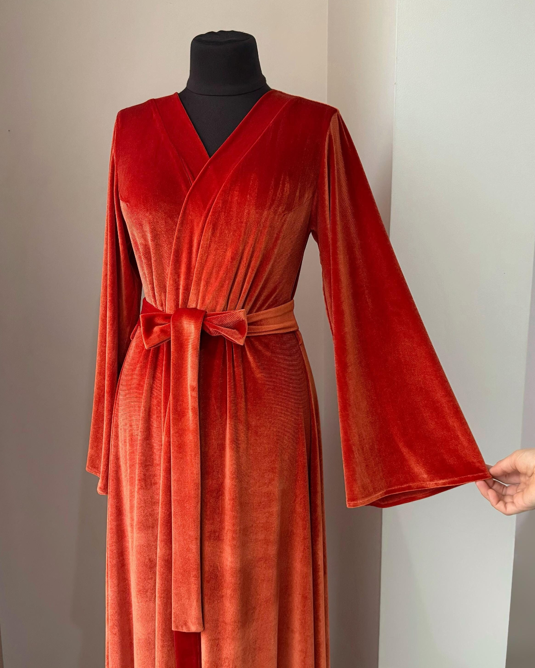 a woman's red robe on a mannequin