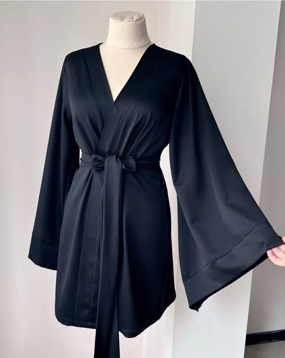 a woman's black robe on a mannequin