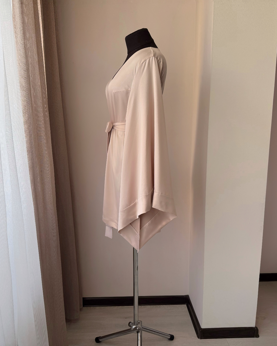 a dress on a mannequin in front of a window