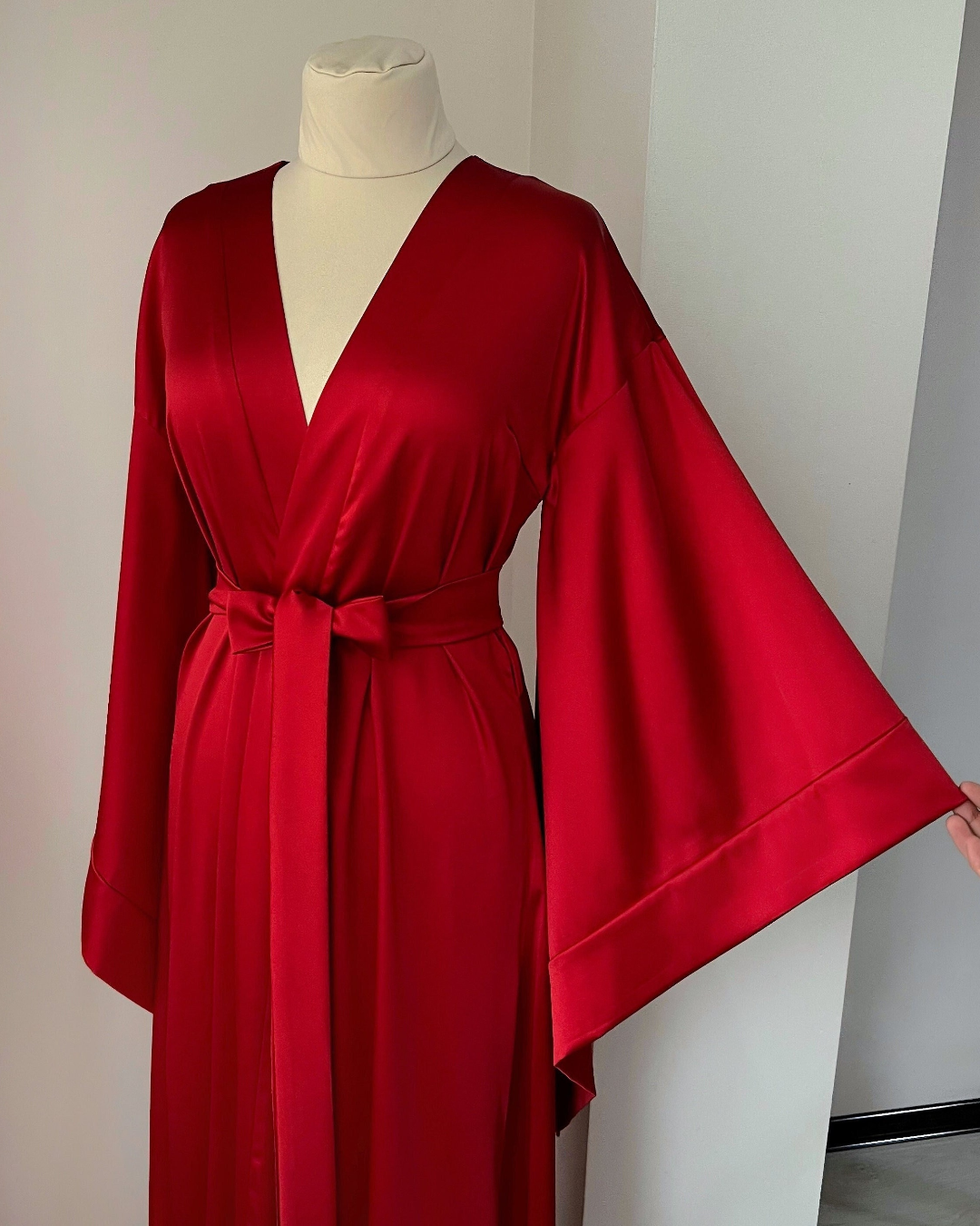 a woman's red robe on a mannequin