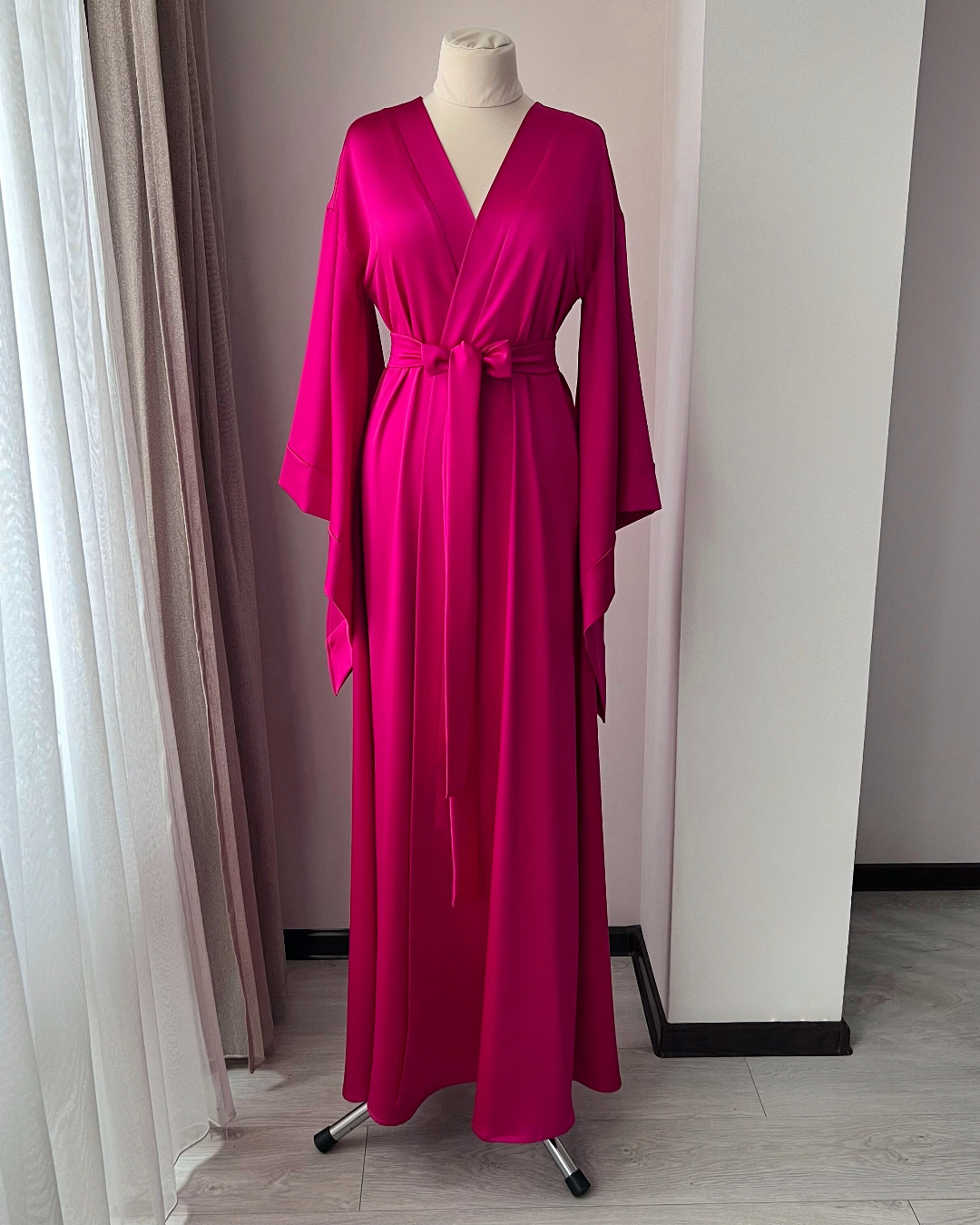 a woman's pink dress on a mannequin