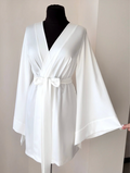 a white robe is on a mannequin