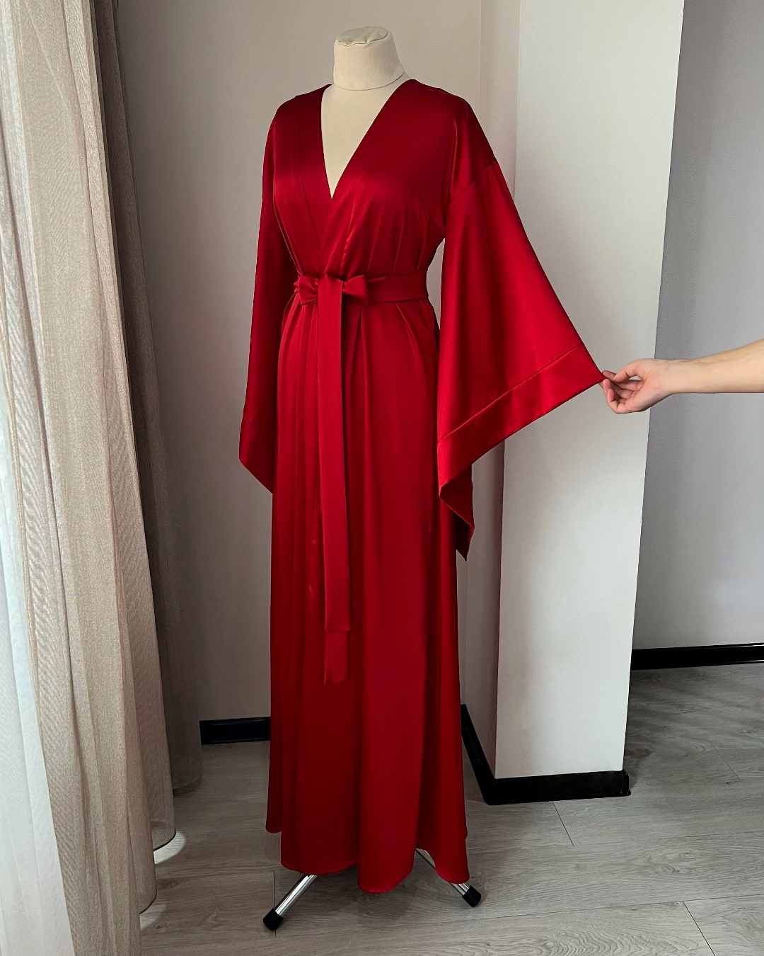 a woman's red robe on a mannequin